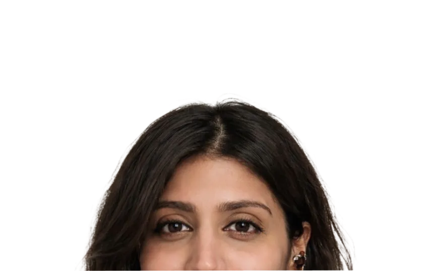 Radha peeking over the bottom edge, looking directly at the camera with dark wavy hair and brown eyes